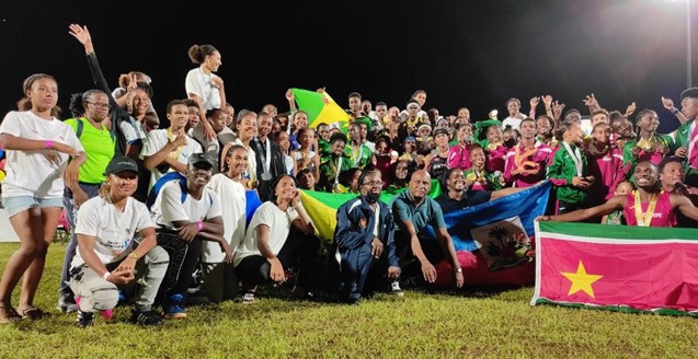 The victorious Guadeloupe team celebrate following the conclusion of the Games