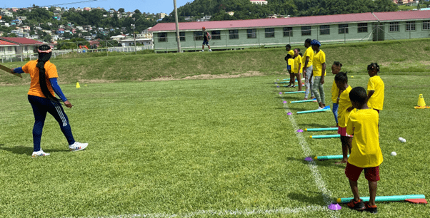 Coach demonstrating the throwing of the Javelin